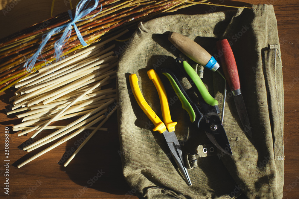 Wall mural Tools for weaving of wicker table in the workshop. Flat lay.