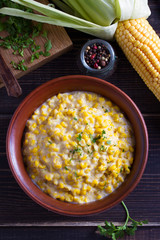 Sweet and creamy skillet corn. Homemade corn dish. View from above, top studio shot
