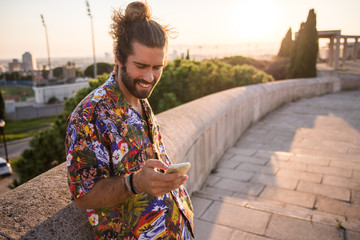 young man with long hair using his mobile phone