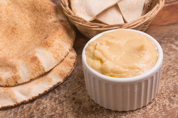 Chickpeas hummus in a bowl and arab bread