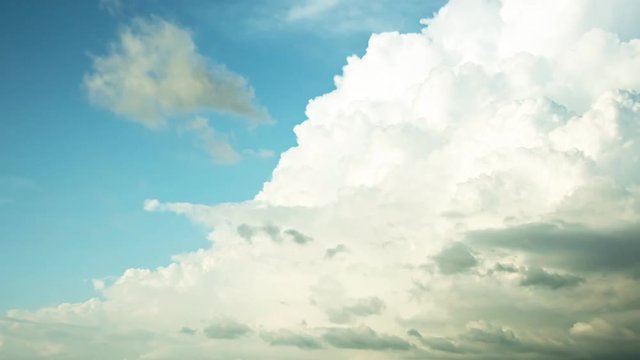 Time lapse of motion flowing white clouds in the blue sky 4K 3840x2160 resolution of white puffy clouds fast moving,good nature footage for background