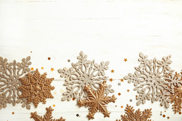 Composition with snowflakes and space for text on wooden background, top view. Festive winter design