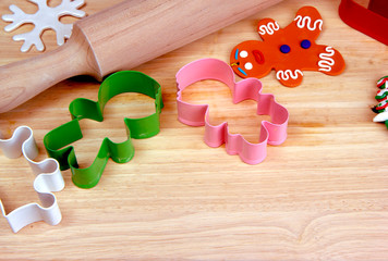 Wooden rolling pin and cutting board, cookie cutters, gingerbread man. Christmas and New Year holiday background concept. Copy space for text.