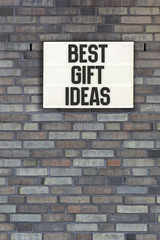 Fototapeta na wymiar Best Gift Ideas in light box on brick wall