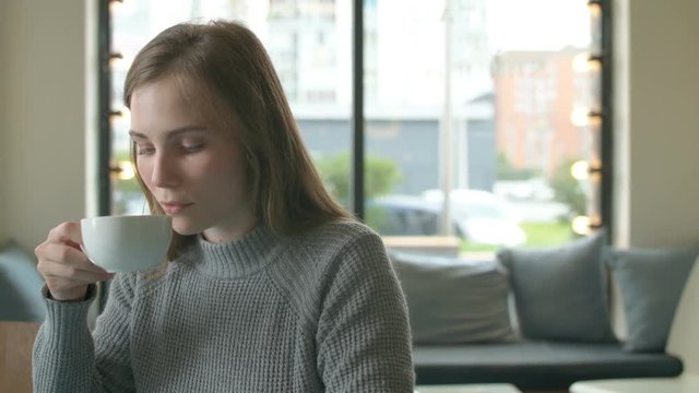 Happy Young Woman With Smartphone In Cafe