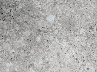Close up of a rough grainy floor tile texture.
