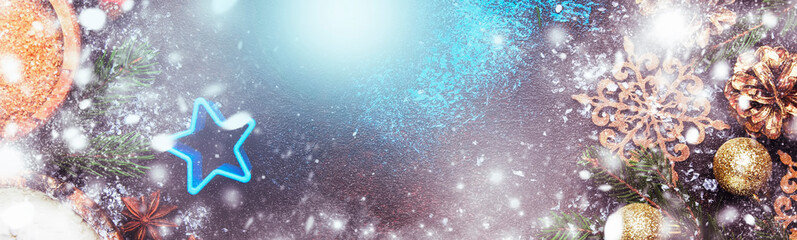 Christmas or New Year composition with ingredients for baking with golden snowflakes, Christmas balls, green fir branches, pine cones, on blue brown background, frame, banner, top view