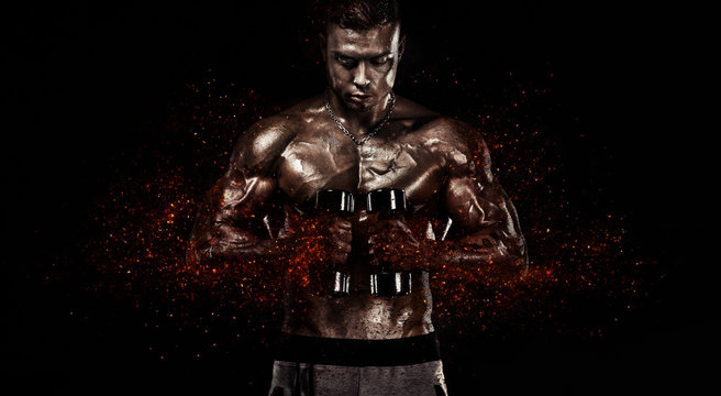 Muscular fitness sports man, atlete with dumbbell in fitness gym. Fire and power.