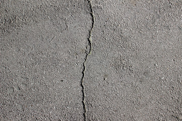 Obraz premium Street asphalt pavement surface texture with cracks