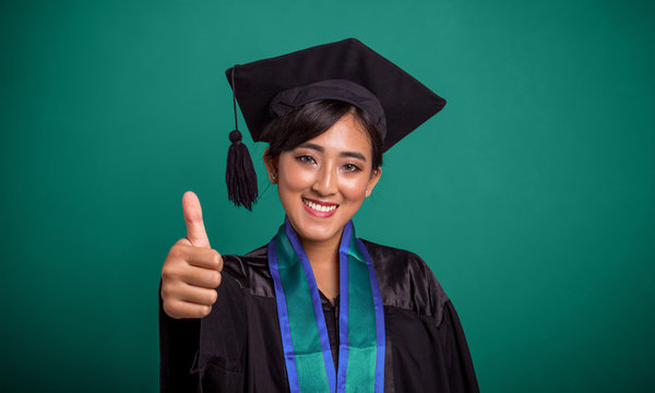 Beautiful smiling graduate student thumb up, over green banner