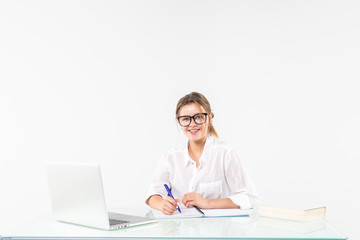 Portrait of an adorable business woman working at her desk with a laptop and paperwork isolated on white background