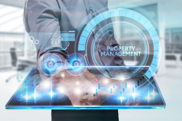 The concept of business, technology, the Internet and the network. A young entrepreneur working on a virtual screen of the future and sees the inscription: Property management