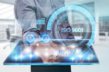 The concept of business, technology, the Internet and the network. A young entrepreneur working on a virtual screen of the future and sees the inscription: ISO 9001