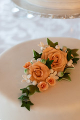 The wedding cake with orange flower decorations