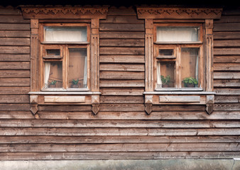 Fototapeta na wymiar The facade of the old wooden houses with windows