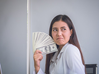Business woman showing bill of dollars  with smiling to successful for work.