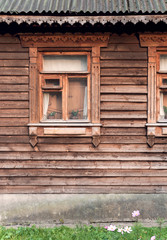 Window on the facade of the old wooden house
