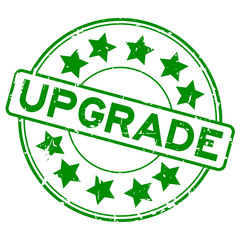 Grunge green upgrade wording with star icon round rubber seal stamp on white background