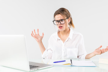 young attractive businesswoman frustrated and desperate expression at office working on computer laptop in stress at work concept screaming angry isolated on white background