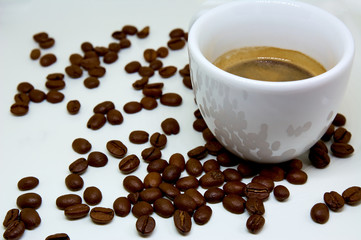 A cup of coffee on the background of coffee beans