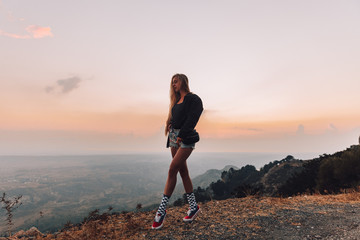 Girl in the mountains at sunset