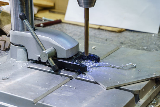 drilling process on small drill press close-up - Powered by Adobe