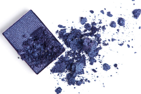 top view of cracked blue eyeshadow on white backdrop