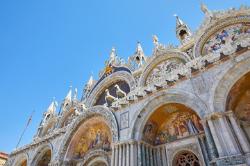 Saint Marck basilica facade low angle view with mosaics in Venice, blue sky in a sunny day in Italy