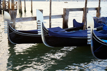 Fototapeta na wymiar Three gondola boats moored in Grand Canal in Venice, Italy