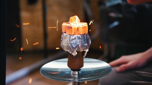 Heated up embers in a cup for a hookah