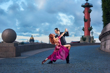 Young, beautiful and professional couple dancing tango in Saint-Petersburg at Vasilyevsky Island on...