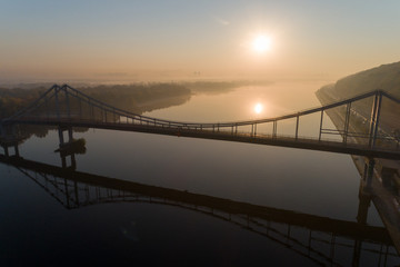Sunrise aerial view of pedestrian Park bridgу, left bank of Kyiv and Dnipro river in Kyiv, Ukraine