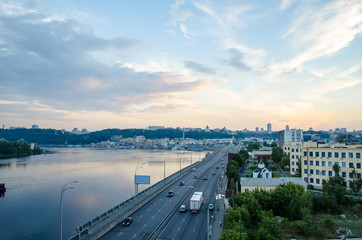 A beautiful sunset over the city. Industrial landscape with city river and view of the city Kiev center.
