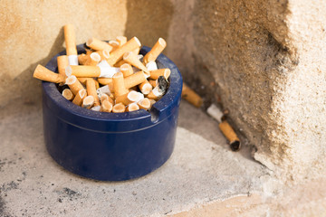 cigarettes in a blue glass close-up. Cigarettes closeup with copy space. World no tobacco day background. Stop quit smoking background.