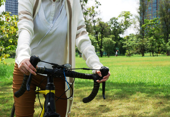 Beautiful girl teen ride bicycle in the public park.