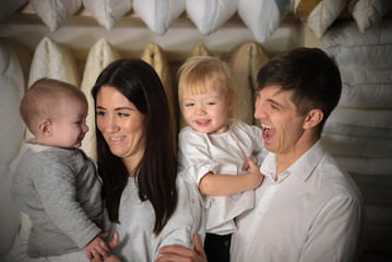 Fototapeta na wymiar Young family on shopping. Portrait of whole family, smiling