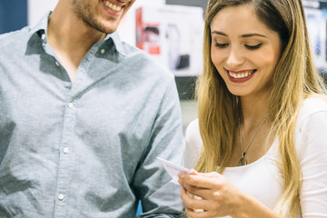 Happy couple looking at the features of an appliance
