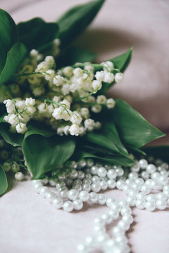 bouquet lilies of the valley in the interior and pearl beads. soft focus
