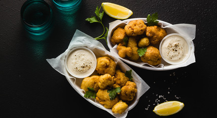 banner of Fried cauliflower in batter with a savory sauce of cashew nuts. healthy vegan fast food. Baked Buffalo Cauliflower 
