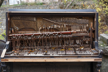 The insides of an old ruined piano