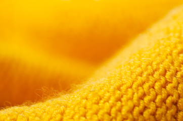 Yellow warm fabric texture material sweater on blur background