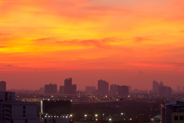 Fototapeta na wymiar Cityscape Lights And Purple orange Sky background at twilight time