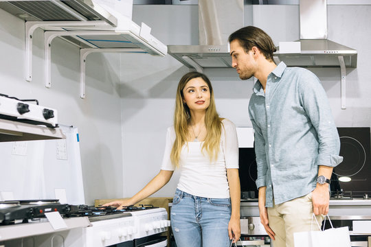Woman and man choosing appliances