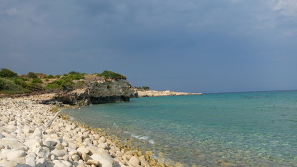 Fototapeta na wymiar Amazing beach at the Ionian Sea, in the province of Syracuse, Sicily. The beach is part of the Oriented Nature Reserve Cavagrande.