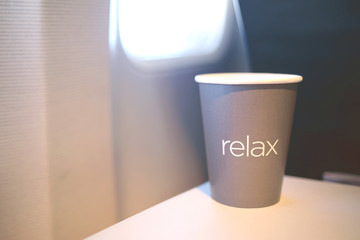 Paper Cup with coffee or tea on the plane