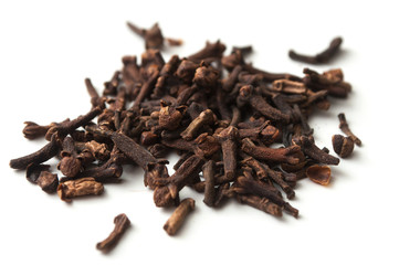 closeup of cloves pile on white background