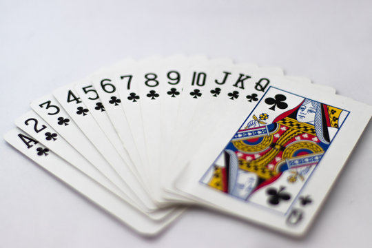 Playing Cards fanned out: Suit of Spades, Clubs and Diamonds fanned out over white background. Gambling, Poker, Win, Lose, Chance, Gambling, Money, Red, Black, Jack, Queen, King