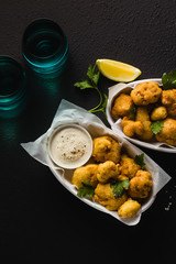 Fried cauliflower in batter with a savory sauce of cashew nuts. healthy vegan fast food. Baked...