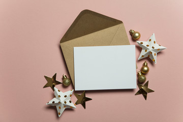 Christmas card template mock up. Blank card with envelope on pink background
