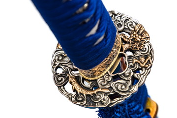 Round Dragon Tsuba : handguard of Japanese sword made of steel with blue cord isolated in white...